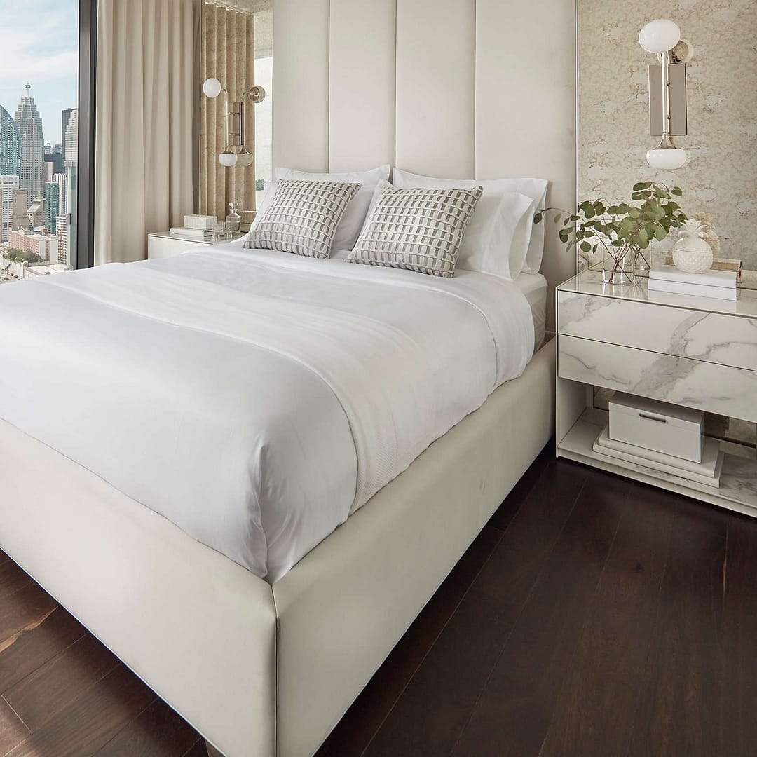 Elegant white bedroom with modern furnishings, designed by House of Layth